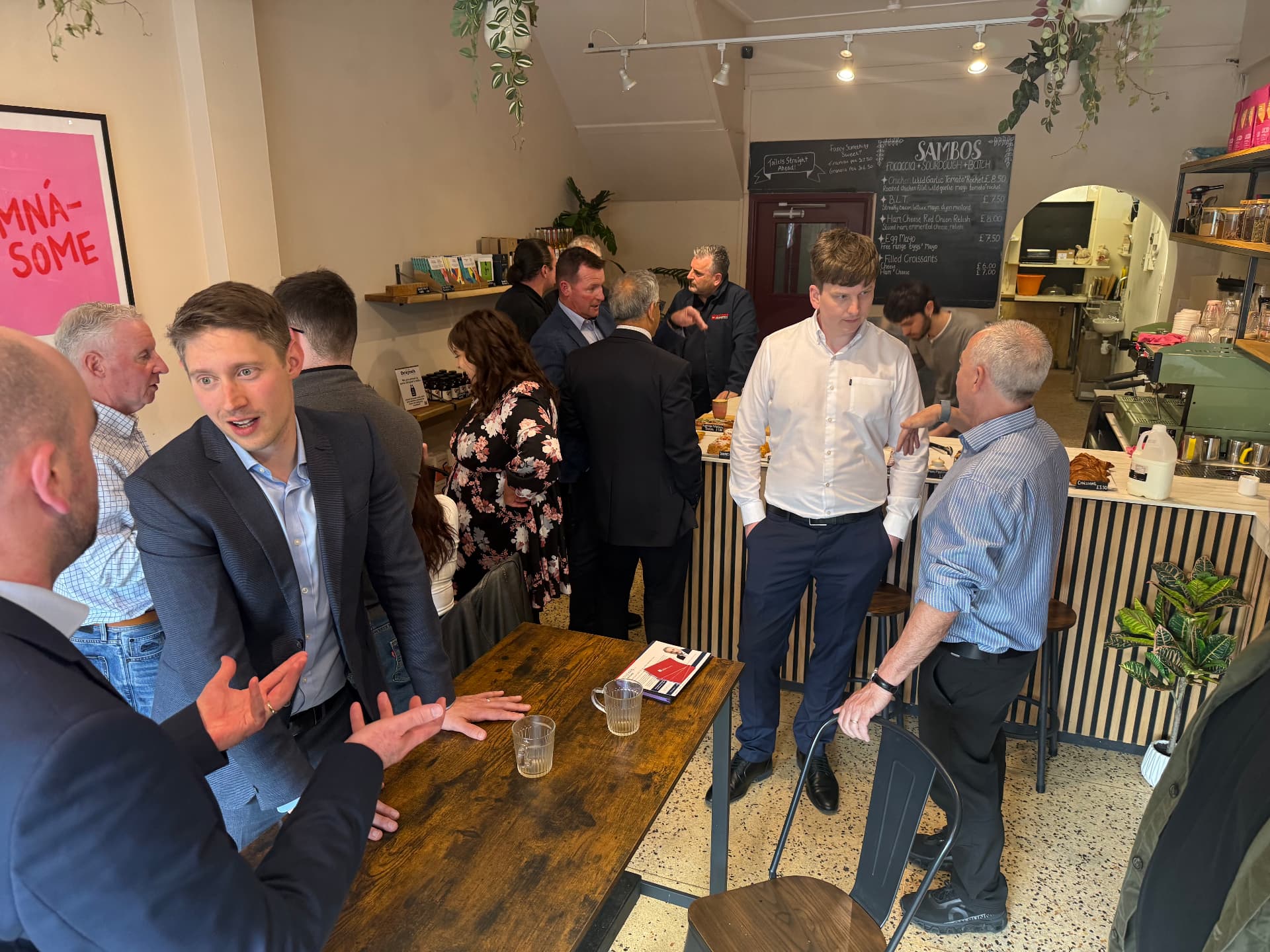 Members in conversation at a small Growth Network gathering in a local bakery