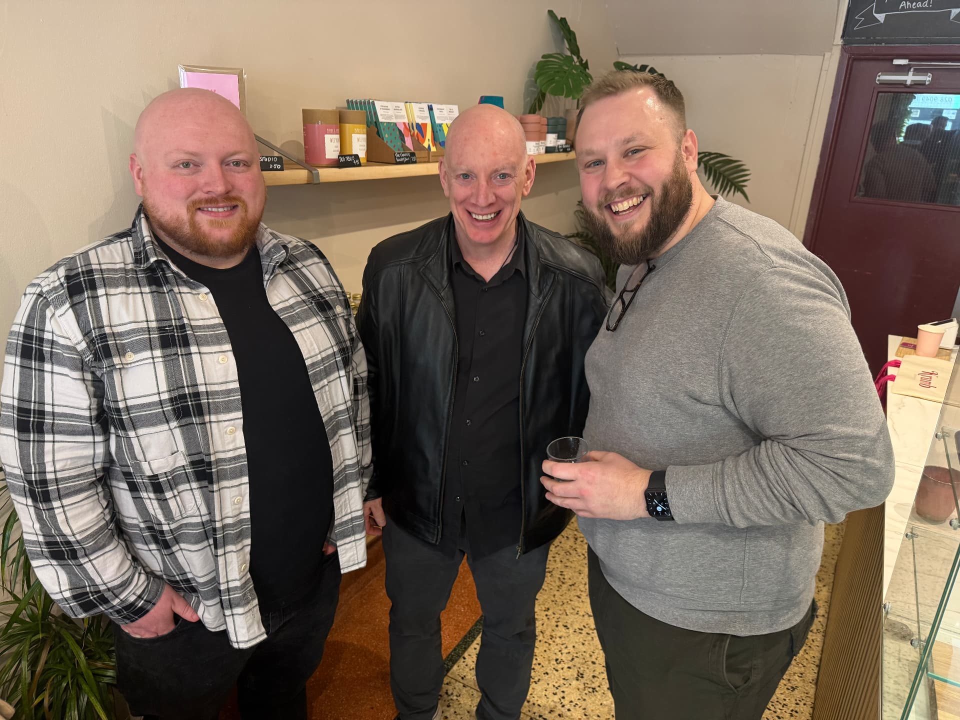 Three members laughing together at a bakery meet-up